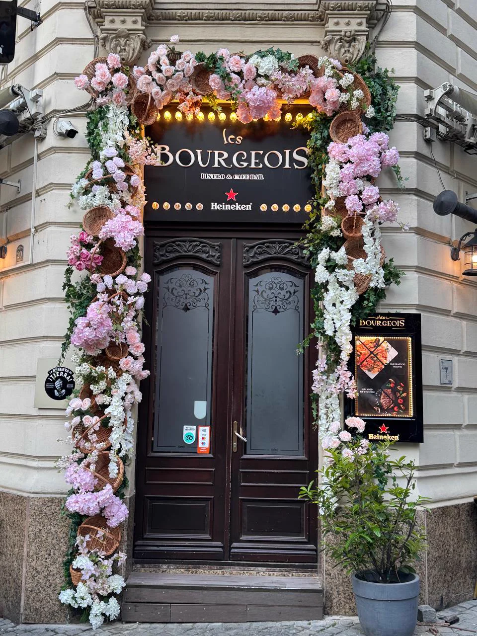 Restaurant entrance framed with pink flowers