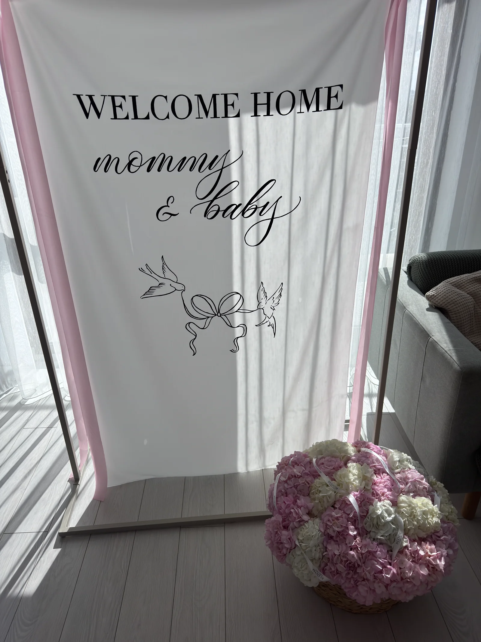 Welcome home banner with a basket of hydrangeas